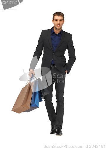 Image of handsome man in suit with shopping bags