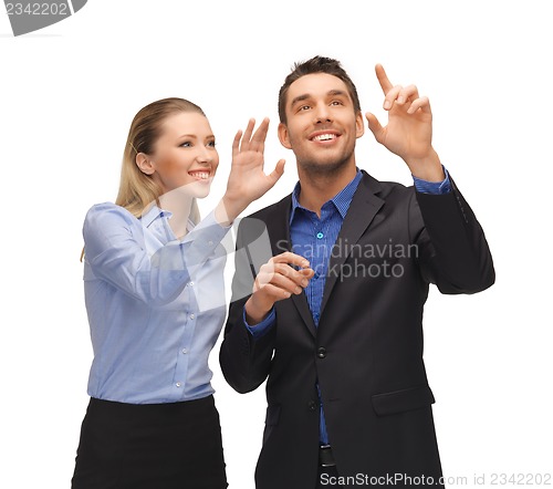 Image of man and woman working with something imaginary