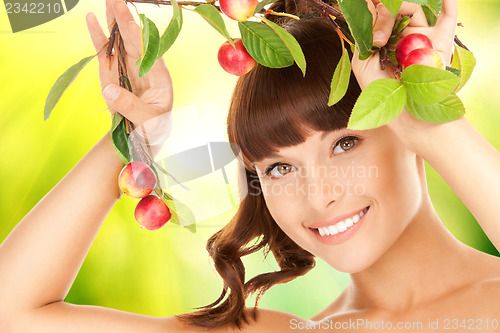 Image of lovely woman with apple twig