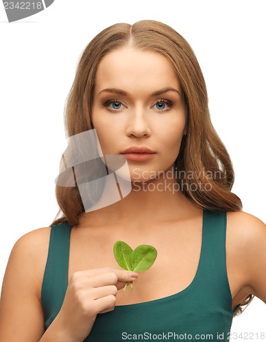 Image of woman with spinach leaves on palms