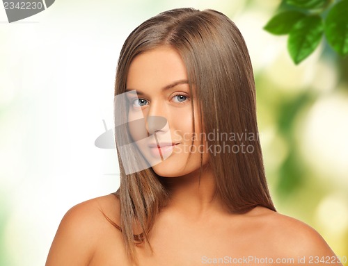 Image of beautiful woman with green leaves