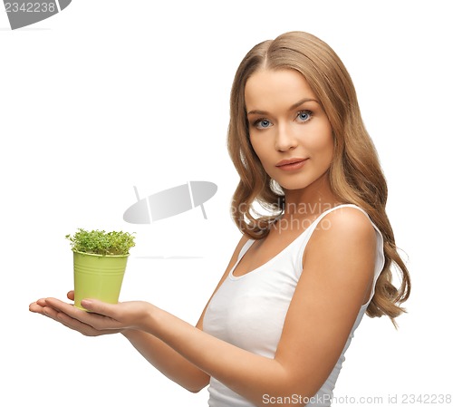 Image of woman with green grass in pot