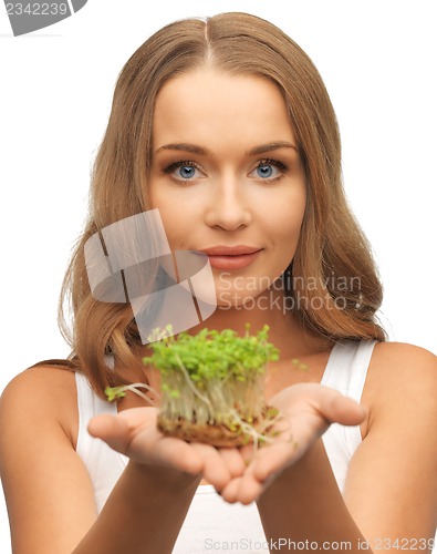 Image of woman with green grass on palms