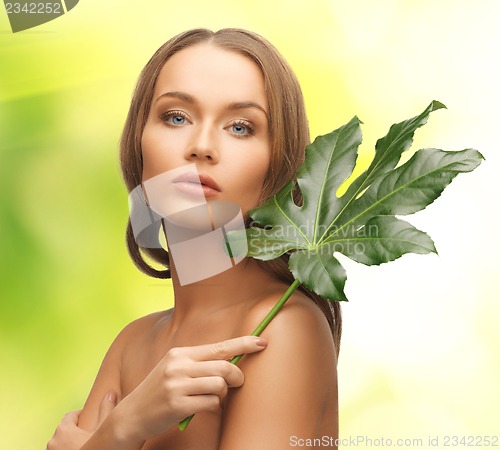 Image of woman with green leaf