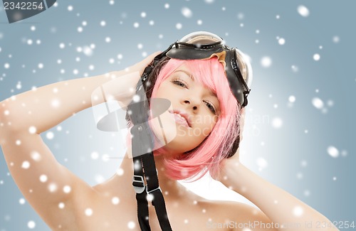 Image of pink hair girl in aviator helmet with snow