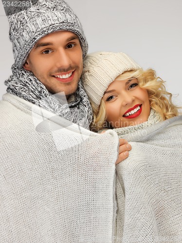Image of family couple under warm blanket