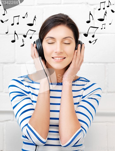 Image of happy teenage girl in big headphones
