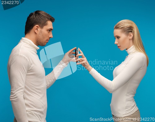 Image of man and woman with modern gadgets