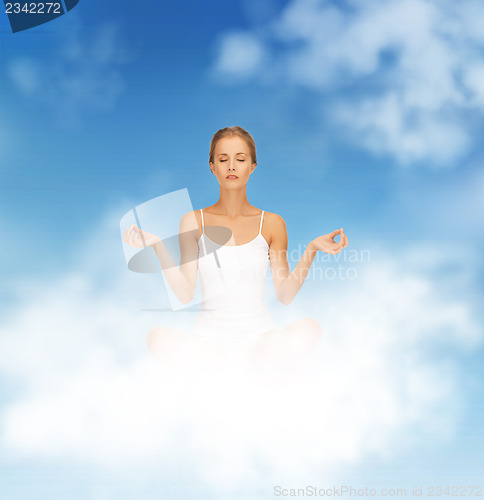 Image of woman in undrewear practicing yoga lotus pose