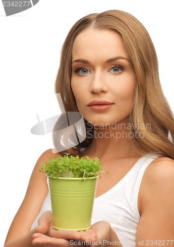 Image of woman with green grass in pot