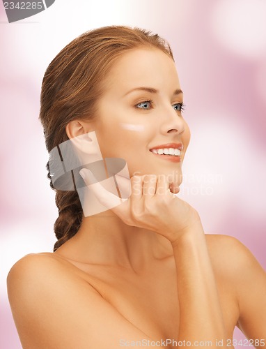 Image of beautiful woman with moisturizing creme drop