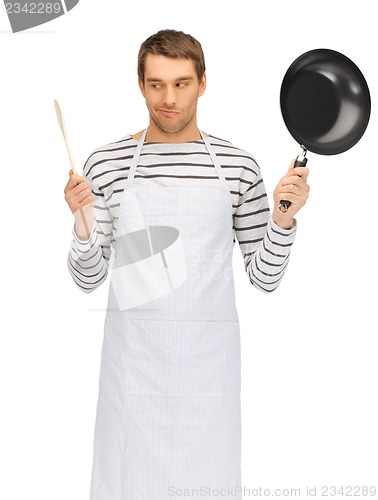 Image of handsome man with pan and spoon