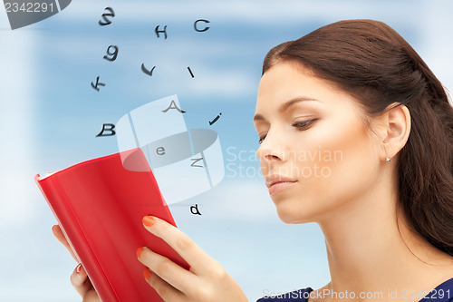 Image of calm and serious woman with book