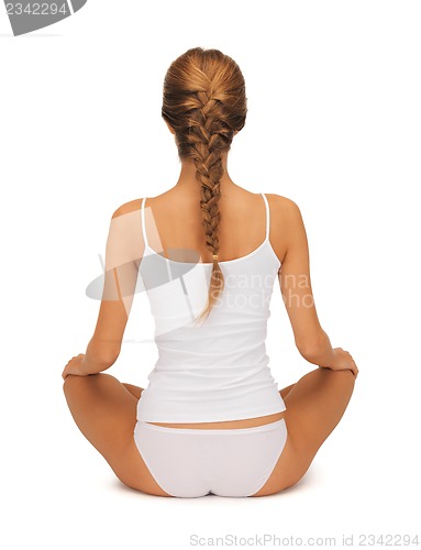 Image of woman in undrewear practicing yoga lotus pose