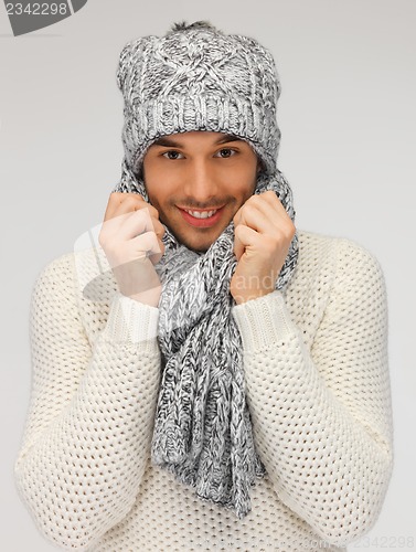 Image of handsome man in warm sweater, hat and scarf