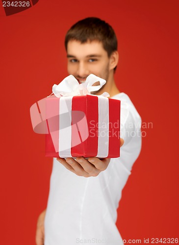 Image of handsome man with a gift