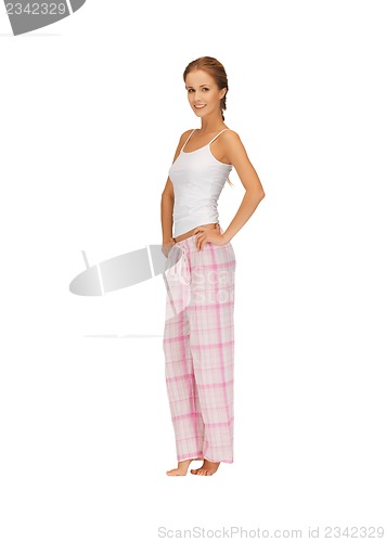 Image of happy and smiling woman in cotton pajamas