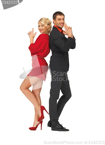 Image of man and woman making a gun gesture