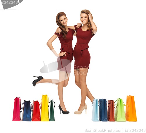 Image of teenage girls in red dresses with shopping bags