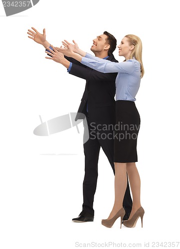 Image of man and woman making a greeting gesture