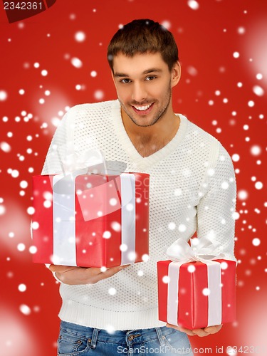 Image of man holding many gift boxes