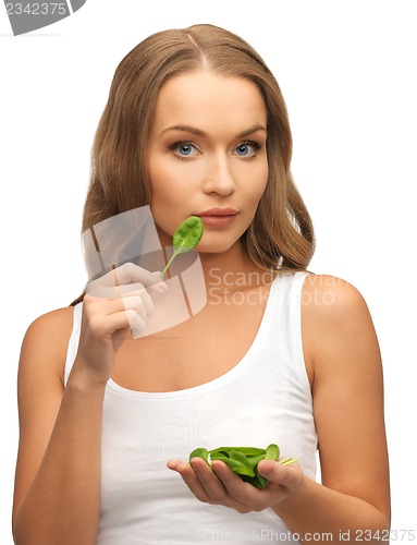 Image of woman with spinach leaves on palms