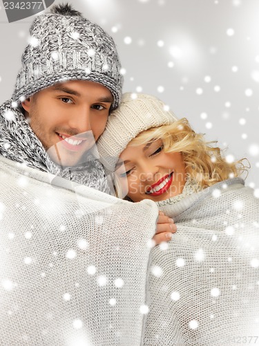 Image of family couple under warm blanket