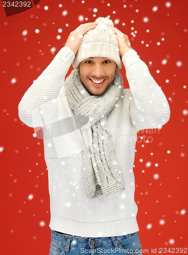 Image of handsome man in warm sweater, hat and scarf