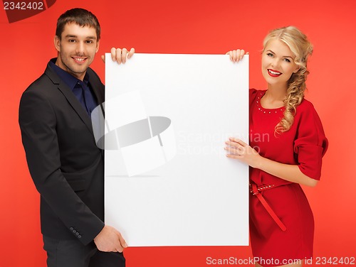 Image of couple holding big blank board