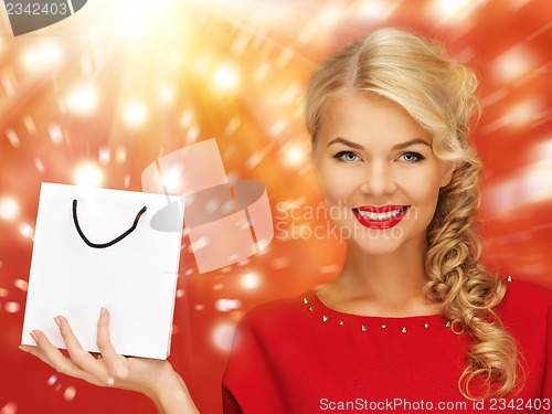 Image of lovely woman in red dress with shopping bag
