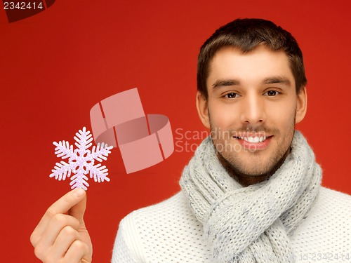 Image of man in warm sweater and scarf with snowflake