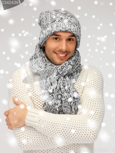 Image of handsome man in warm sweater, hat and scarf