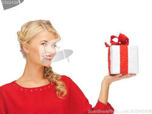 Image of lovely woman in red dress with present