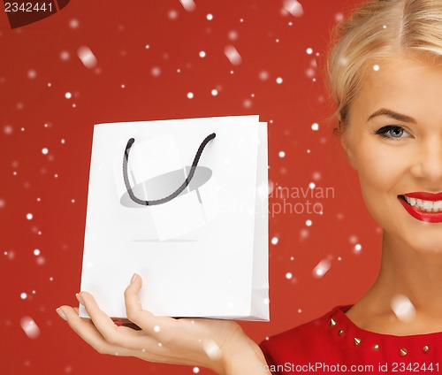 Image of lovely woman in red dress with shopping bag