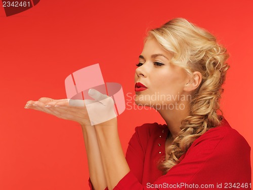 Image of woman blowing something on the palms of her hands