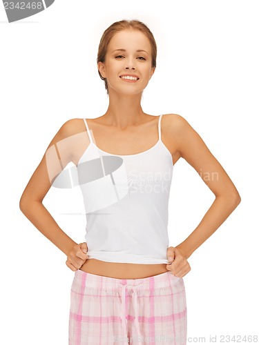 Image of happy and smiling woman in cotton pajamas