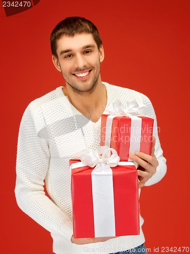 Image of man holding many gift boxes