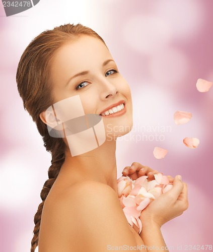 Image of beautiful woman with rose petals