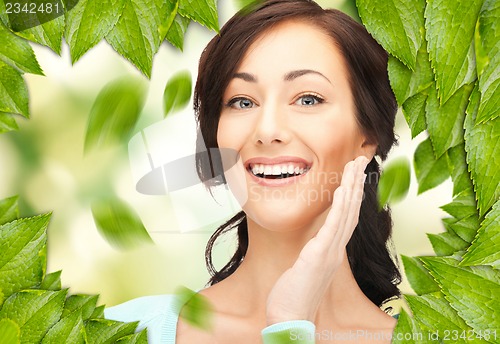 Image of beautiful woman with green leaves