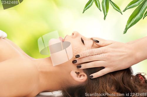 Image of beautiful woman in massage salon