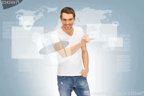 Image of handsome man working with touch screen