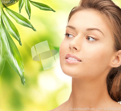 Image of beautiful woman with green leaves