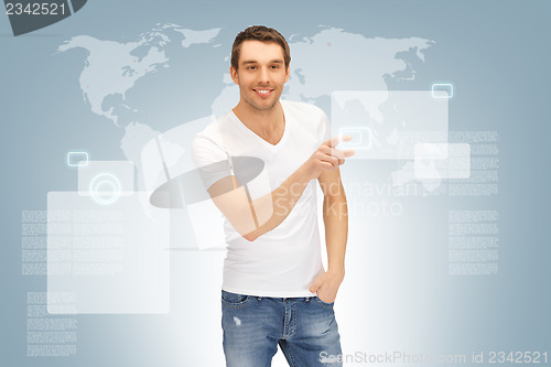 Image of handsome man working with touch screen