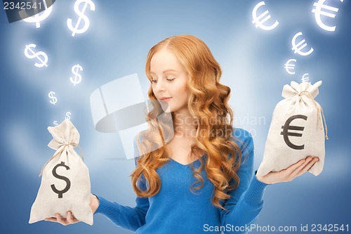 Image of woman with euro and dollar bags