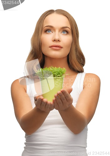 Image of woman with green grass in pot