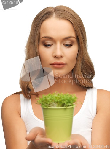 Image of woman with green grass in pot