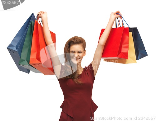 Image of teenage girl in red dress with shopping bags