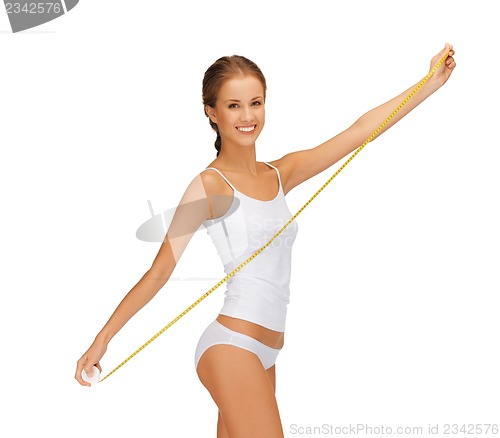 Image of young beautiful woman with measure tape