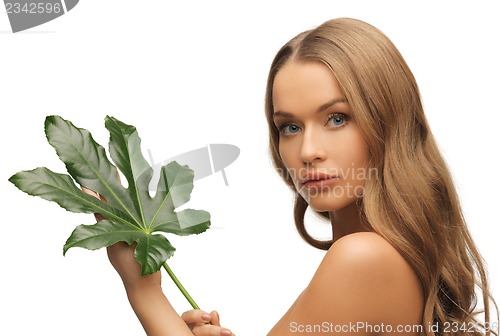 Image of woman with green leaf