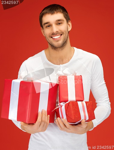 Image of man holding many gift boxes